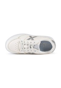 White leather sneaker with silver accents, perforated toe, flat laces, padded tongue, and a grey insole. Smooth texture and low-profile design.