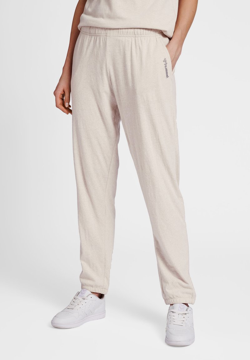 Light beige jogger pants made of soft fabric, featuring an elastic waistband, cuffed hems, and a subtle brand logo on the side.