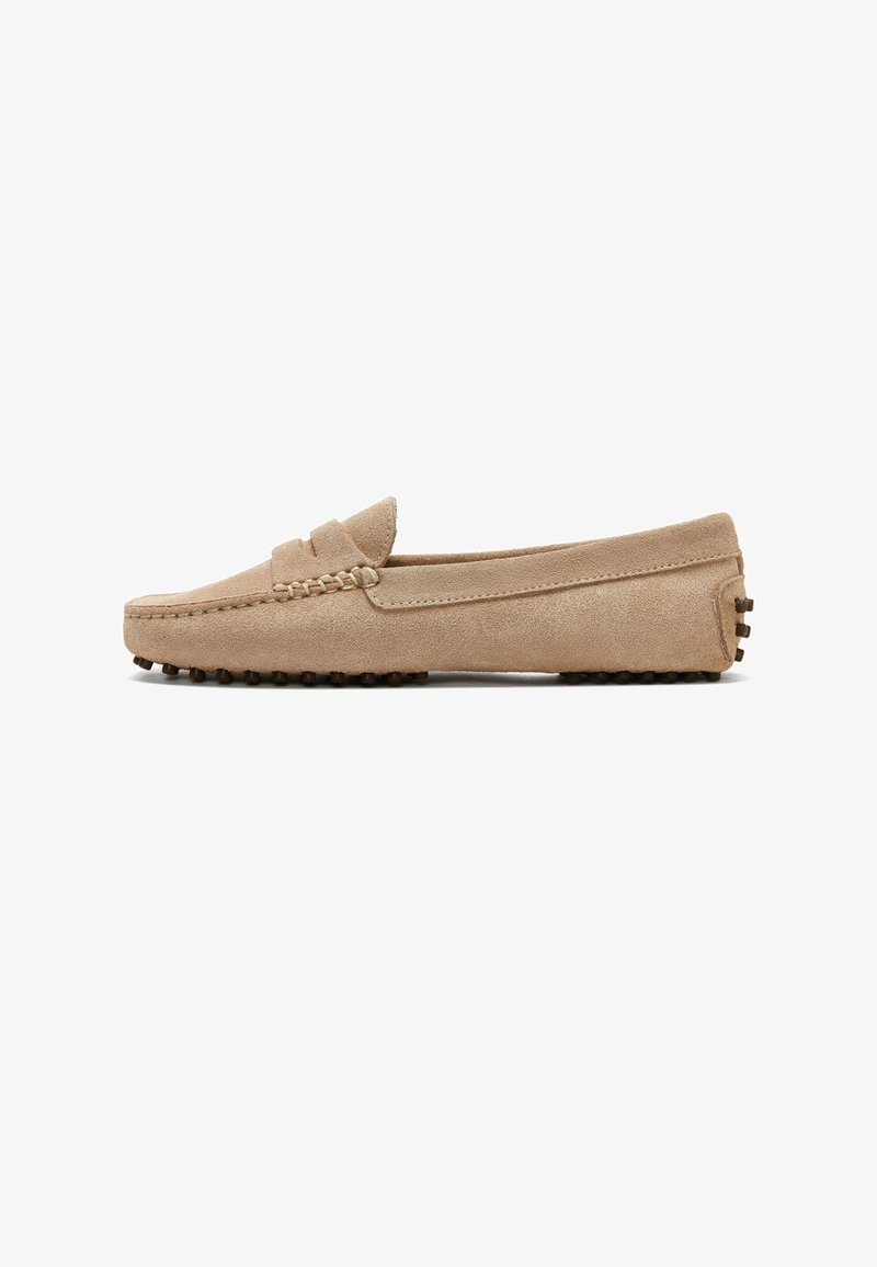 Beige suede men's loafer with stitched toe, low heel, and rubber studded sole, viewed from the side on a white background.