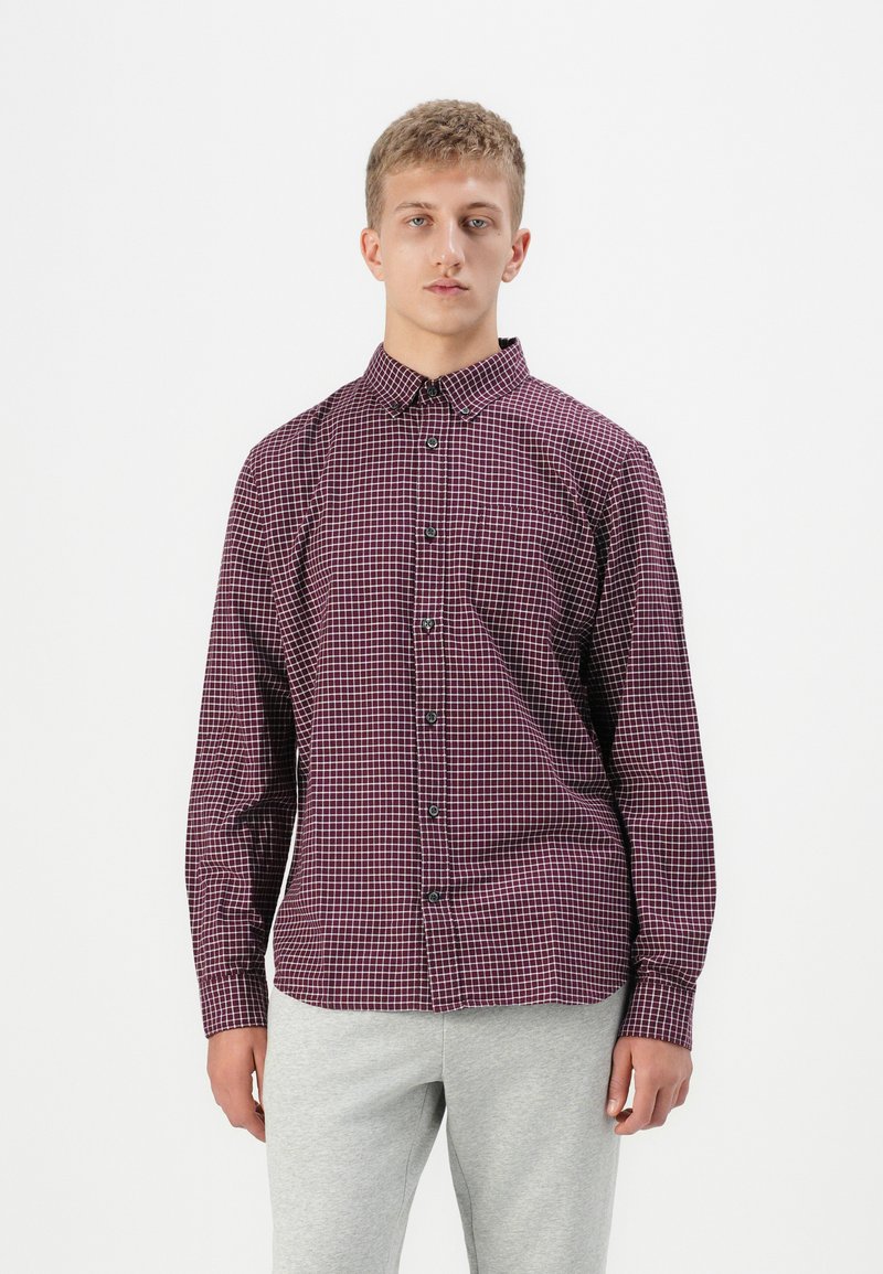 Red and black checkered long-sleeve shirt with a button-down collar and black buttons. Cotton fabric with a smooth texture.