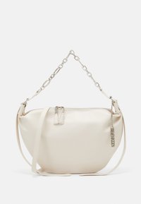 Beige leather bag with a curved shape, silver chain strap, and zipper closure. Features dual zipper pulls and a branded metal charm.