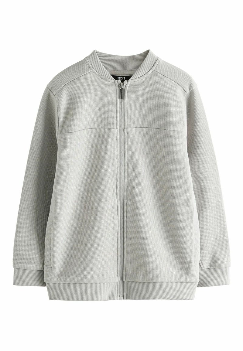 Hellgraue Zip-Jacke mit strukturiertem Finish, geripptem Kragen und Bündchen sowie geradem Schnitt. Verfügt über zwei seitliche Taschen.