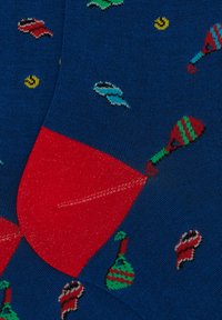 Knit socks featuring a blue base with colorful fish and ornaments, a red heel, and a smooth texture, ideal for casual wear.