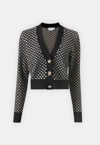 Μαύρη και κρεμ ζακέτα με διαμαντένιο σχέδιο, V-λαιμόκοψη, μακριά μανίκια και τρία κουμπιά στο μπροστινό μέρος. Ριχτά μανίκια και τελείωμα.