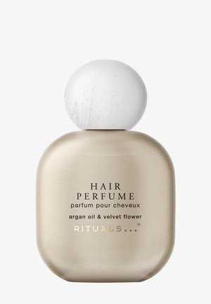 Haarparfumfles met een ronde, matte gouden basis en een witte houten dop. De tekst omvat "HAAR PARFUM" en geurdetails.