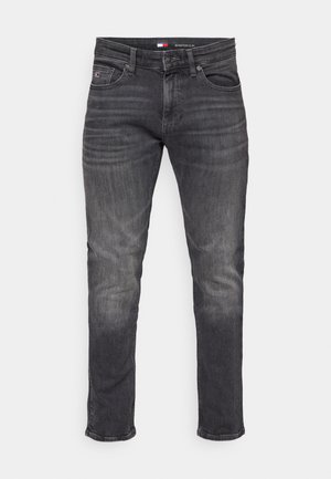 Slim-fit ciemnoszare dżinsy o wyblakłej teksturze, pięć kieszeni oraz logo na pasku. Jednolity kolor z subtelnymi różnicami w odcieniach.