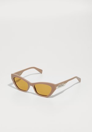 Pink cat-eye sunglasses with yellow lenses, featuring thick frames and the brand name "LIU JO" embossed on the arm in white.