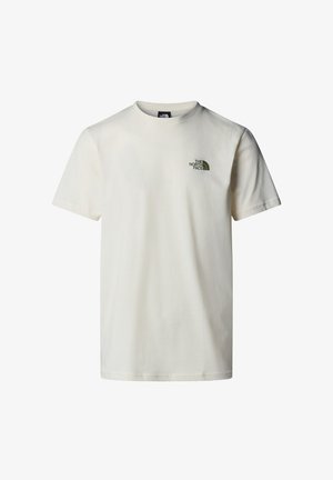 T-shirt en coton couleur crème avec manches courtes, encolure ronde et un petit logo vert sur la poitrine gauche. Texture lisse, design décontracté.