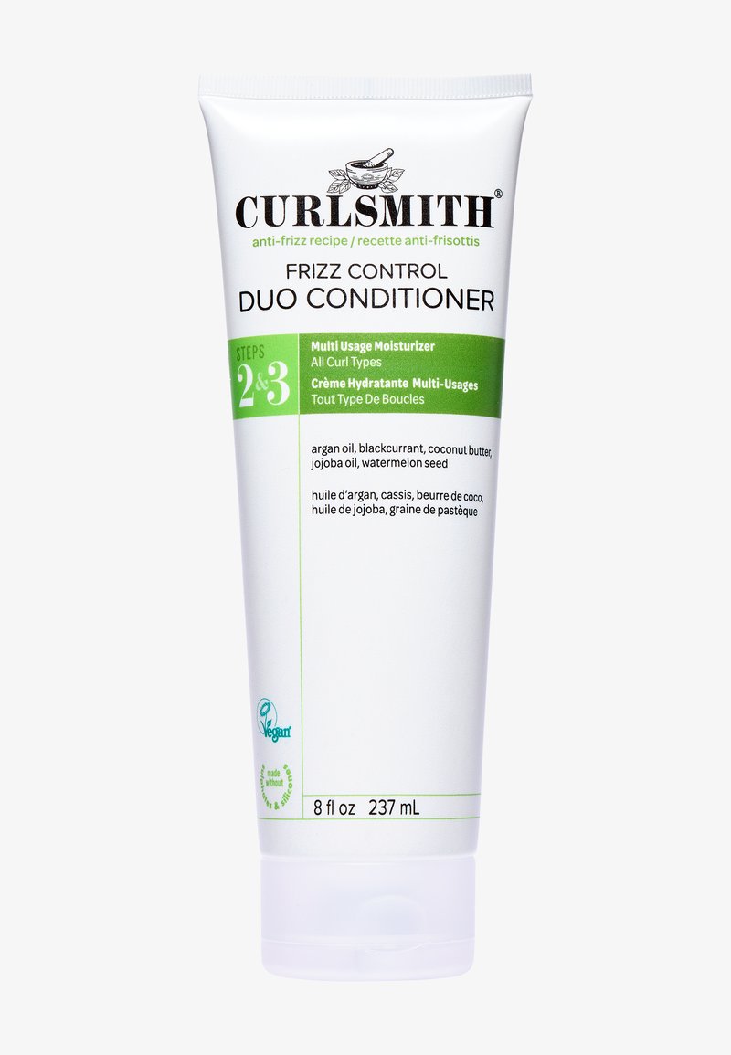 Balsamo Curlsmith Frizz Control Duo in un tubo bianco con dettagli verdi; presenta etichette testurizzate che descrivono ingredienti e modalità d'uso. Formato 237 mL.