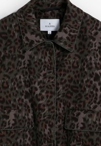Dark brown leopard print jacket with beaded trim along collar, front, and pocket edges, labeled Scalpers size medium.