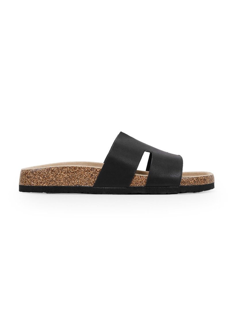 Black leather slide sandal with two cut-out straps, cork midsole, and textured rubber outsole. Flat design for comfort and ease of wear.