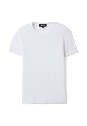 Maglietta bianca semplice a maniche corte con scollo a girocollo e trama a costine, mostrata stesa con un'etichetta del marchio nera visibile sul collo.