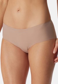 Moda seamless in tono nude, realizzati in un tessuto morbido, con vita bassa e bordi lisci per un comfort ottimale. Senza cuciture o fantasie visibili.