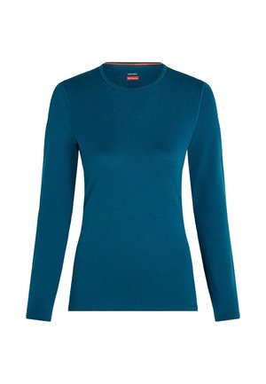 Maglietta a maniche lunghe con scollo rotondo in lana merino di colore blu teal profondo, presentata su uno sfondo bianco.