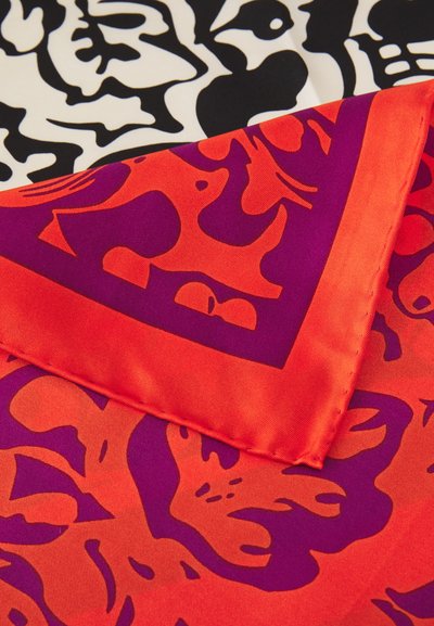 Silk fabric featuring a vibrant red and purple pattern, layered over a black and white floral design with smooth, glossy texture.