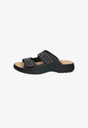 Schwarze offene Sandale mit zwei verstellbaren Klettverschlüssen und einem gepolsterten beigen Fußbett auf einer dicken schwarzen Sohle.