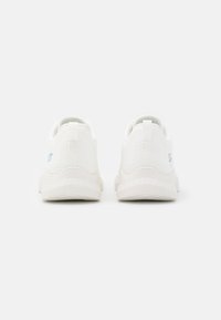 White athletic shoes with a mesh upper, flexible soles, and a subtle blue accent. Features a pull tab at the back for easy wear.
