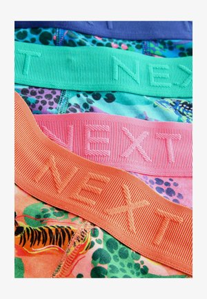 Three colorful underwear waistbands in purple, green, and pink with embossed "NEXT" text, laid on patterned fabric featuring animal designs.
