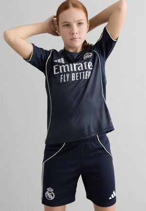 Navy blue athletic uniform featuring short sleeves, light green detailing, and logo accents with a textured design. Includes shorts and jersey.