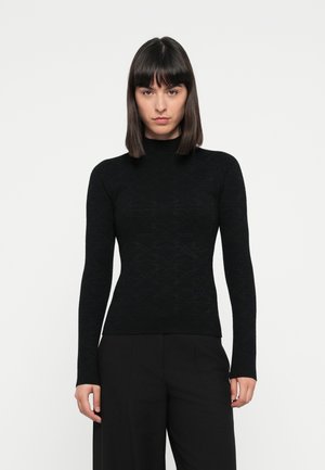 Zwarte lange mouw turtleneck sweater van textuurstof met een subtiele patroonontwerp, getailleerde silhouette en geribde manchetten.
