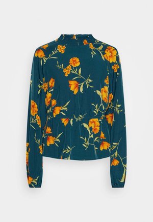 Haut à manches longues en teal avec un col montant froncé et une taille peplum, présentant un imprimé floral orange et des accents feuillus tout au long.