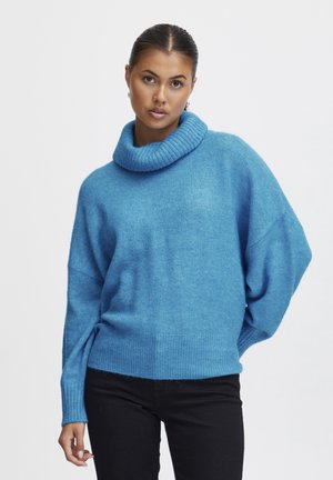 Helles blaues, oversized Sweater mit einem gerippten Kragen. Verfügt über lange Ärmel und ein weites Design, gefertigt aus weichem, strukturiertem Material.