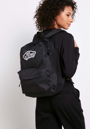 Mochila negra Vans con parche de logo, bolsillo delantero con cremallera, correas ajustables y un acabado de tela texturizada. Adecuada para uso diario.
