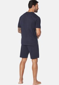 Navy blue cotton short-sleeve T-shirt and matching shorts, featuring a relaxed fit, simple design, and solid color without patterns.