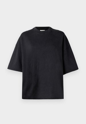 T-shirt oversized preto feito de algodão macio. Apresenta um decote redondo em crew, mangas curtas e uma textura suave. Sem padrões ou acentos visíveis.