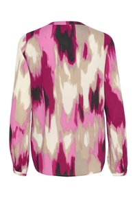 Blouse à manches longues avec un motif abstrait en rose, beige et noir. Dotée d'un col rond et de poignets élastiqués. Texture de tissu douce.