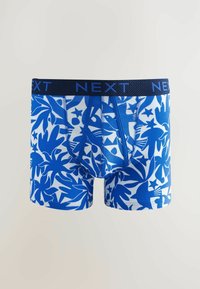 Boxer shorts bleus et blancs avec un motif de feuilles tropicales, une taille élastique noire étiquetée "NEXT" et une coupe ajustée.