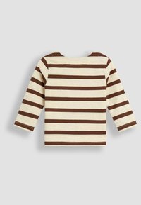 Camiseta de manga larga beige con rayas horizontales marrones, cuello redondo y costuras visibles sobre un fondo gris claro.