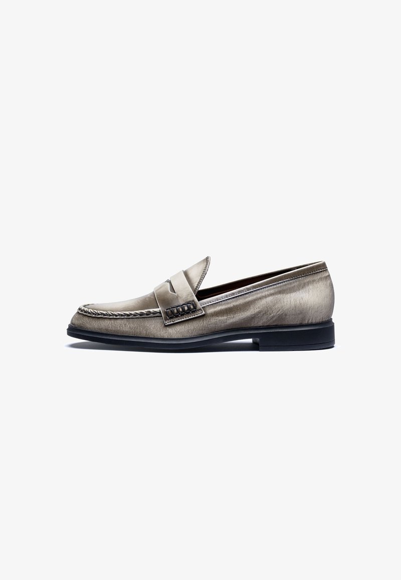 Metallic silver leather loafer with a rounded toe, decorative stitching, and a textured strap across the vamp. Black rubber sole.