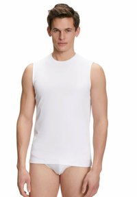 White sleeveless shirt made of smooth fabric, featuring a round neckline and a fitted design, ideal for layering or casual wear.