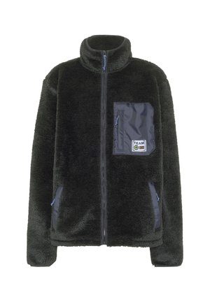 Black fuzzy zip-up jacket with high collar, two side pockets, and a zippered chest pocket featuring a "TEAM" patch.