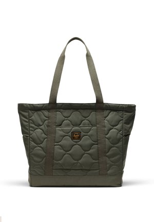 Quilted tote bag in olive green with gray fabric handles. Features a front pocket and textured pattern with a branded tag.
