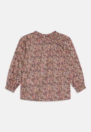 Langermet bluse i blomstermønster med nyanser av rødt, lilla og gult på en lys bakgrunn. Elastisk halslinning og mansjetter.