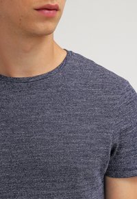 Navy blue short-sleeved t-shirt made of textured fabric with a subtle heather pattern and a classic crew neckline.