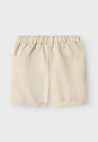 Lichtbeige shorts van gladde stof, met een elastische tailleband en een gestikt zakje aan de linkerzijde.