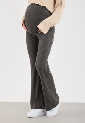 Maternity flared pants in dark gray ribbed fabric, paired with a beige ribbed top. Features a high waistband and a textured surface.