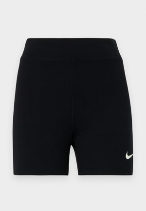 Bermudas deportivas negras hechas de un tejido elástico con una cintura alta. Presenta un pequeño logo blanco de Nike en el lado izquierdo. Textura suave.