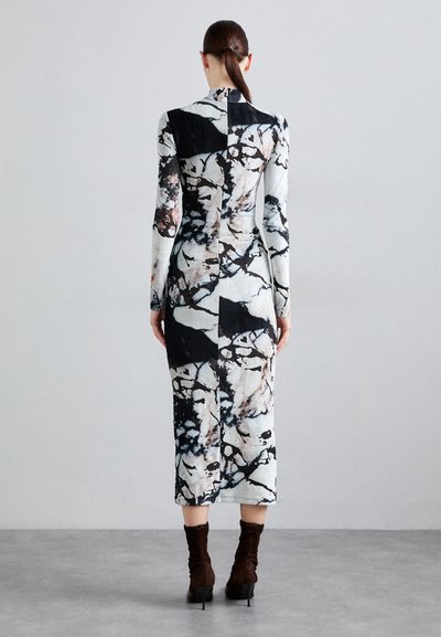 Long-sleeve dress with abstract black and white floral pattern, fitted silhouette, knee-length, textured fabric, high neckline, and seam detailing.