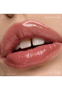 Glossy pink lips slightly parted showing front teeth with a small gap, set against natural skin texture close-up.