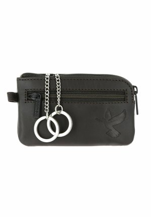 Pochette à clés en cuir noir avec fermeture éclair à l’avant, deux anneaux porte-clés argentés fixés sur des chaînes et motif de colombe embossé en bas à droite.