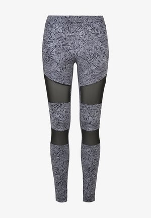 Leggings ajustés noirs avec un motif abstrait blanc. Comprend des panneaux en maille au niveau des cuisses et des mollets, offrant un contraste tactile unique.