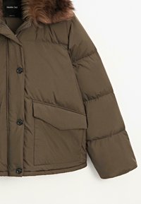 Brown padded jacket with a faux fur collar, featuring a zip closure, black buttons, and a large front pocket. Soft, smooth texture.