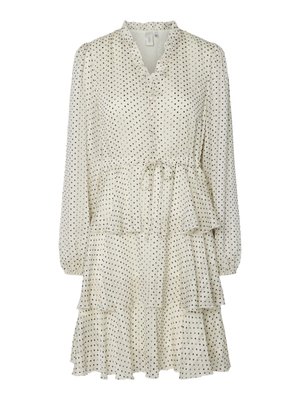 Rochie crem cu buline negre, guler ondulat, mâneci lungi și fustă în straturi. Are talie cu șnur și textură moale a materialului.