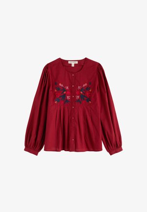 Blusa rossa a maniche lunghe con scollo rotondo, chiusura con bottoni e motivi floreali ricamati in vari colori sul petto.