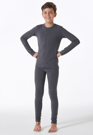 Top gris de manga larga y pantalones ajustados a juego, hechos de mezcla de algodón, con cuello redondo y corte ajustado, usados descalzos.