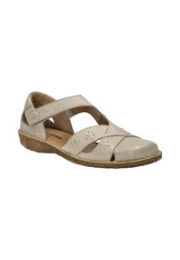 Beige leather sandal with cutout design and a textured rubber sole. Features a wide strap across the ankle for support.